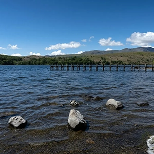 View of Coniston Water in the Lake District, showcasing its calm waters — representing the Mid Tier partnership on the Partner With Us page of Sukanya The Podcast.